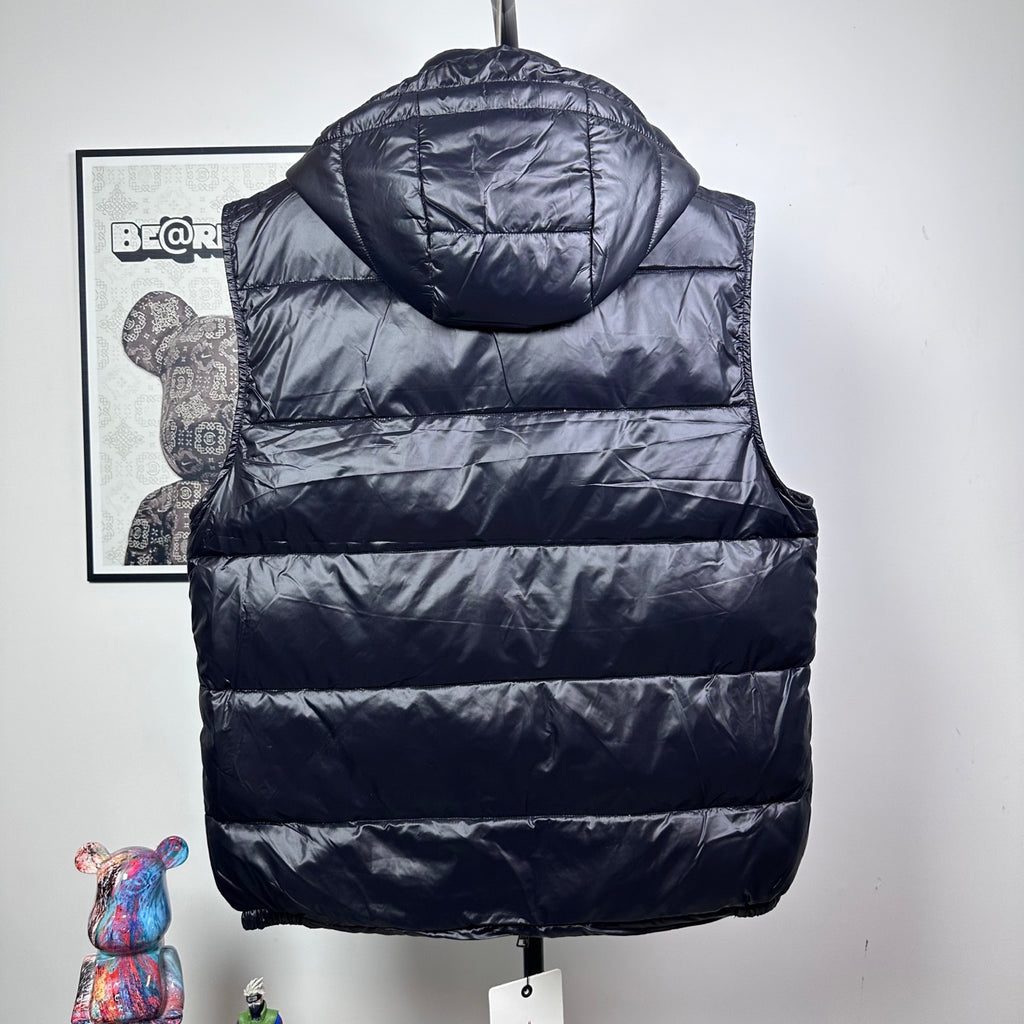 Moncler dark puffer vest back view with hood and horizontal quilted stripes