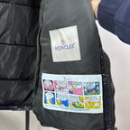 Moncler vest interior labels: white logo tag and colorful comic patch on lining
