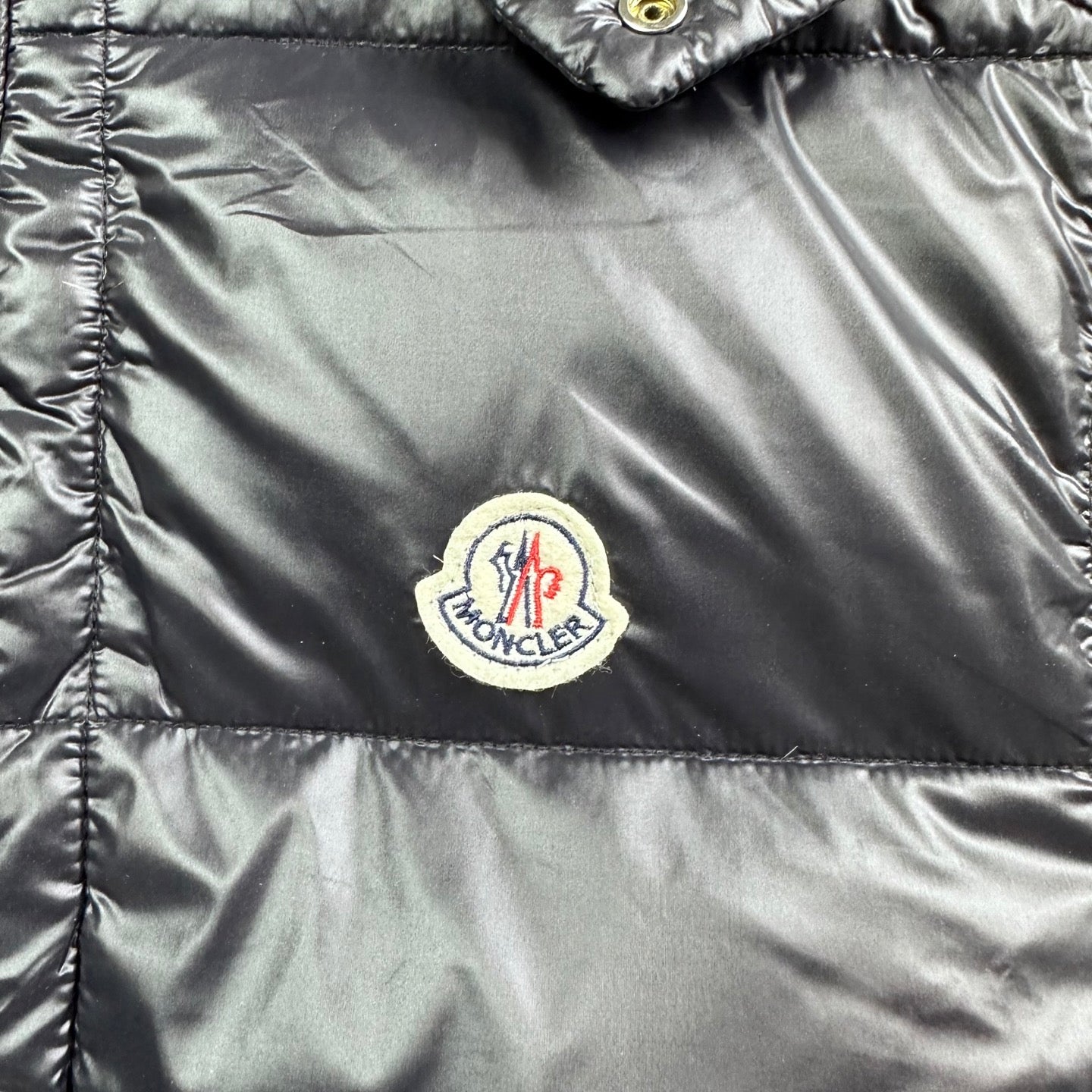 Moncler logo patch on dark satin puffer vest front panel