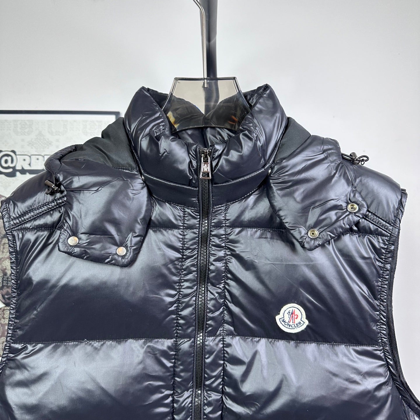 Moncler dark hooded puffer vest with front zipper and chest logo patch