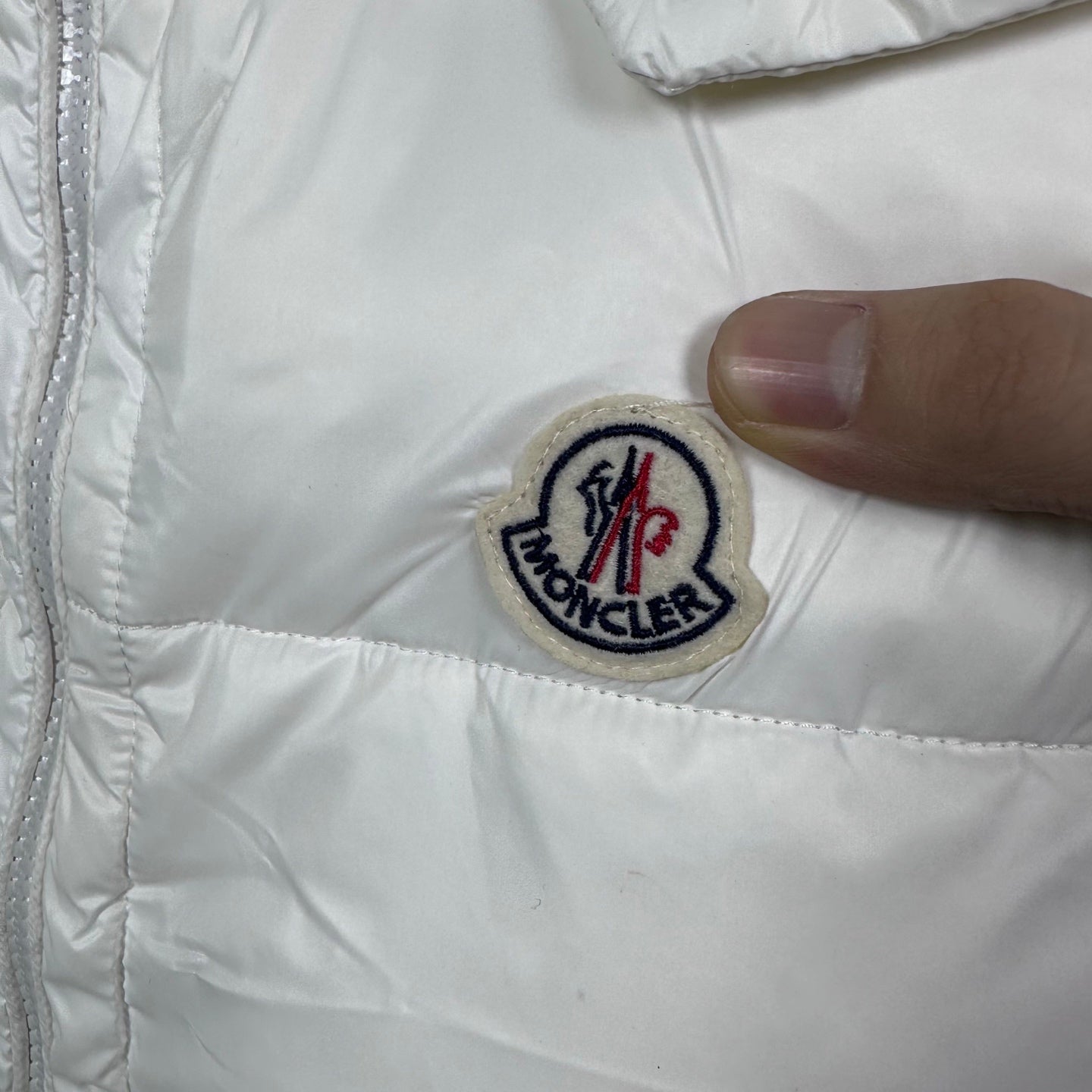 Moncler puffer vest patch logo on white fabric