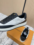 Louis Vuitton low-top sneakers, black and white colorblock, gold LV lace tab