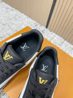 Louis Vuitton sneakers close-up with black tongue and gold LV logo on heel