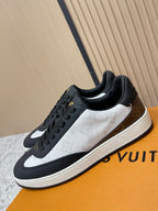 Louis Vuitton low-top sneakers with black laces, white leather panel, gold LV detail