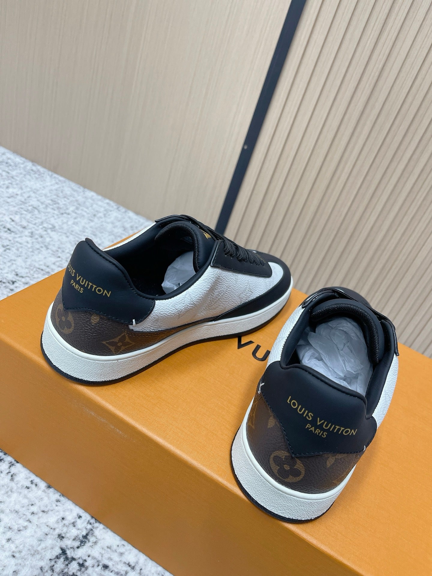 Louis Vuitton low-top sneakers with heel logos, black uppers and white midsole