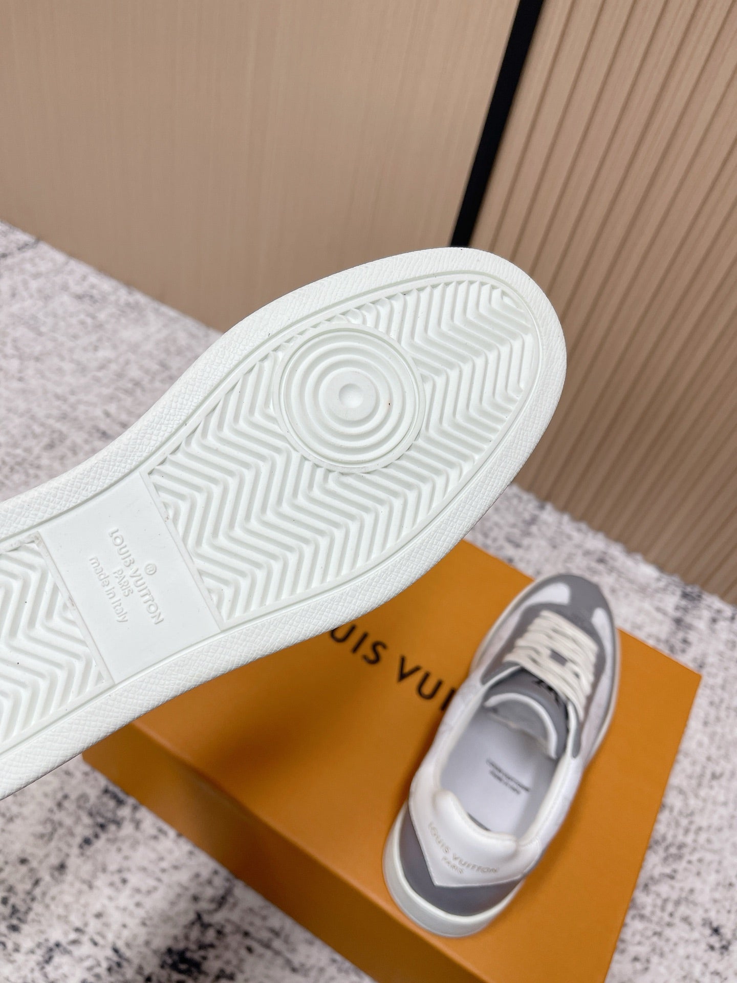 Sneakers with textured rubber outsole tread, white and gray upper, lace-up front
