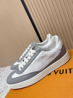 White leather sneakers with gray side stripe, white laces, low profile sole