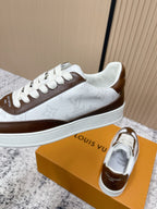 Brown-and-white low-top sneakers angled view with white midsole and lace-up front