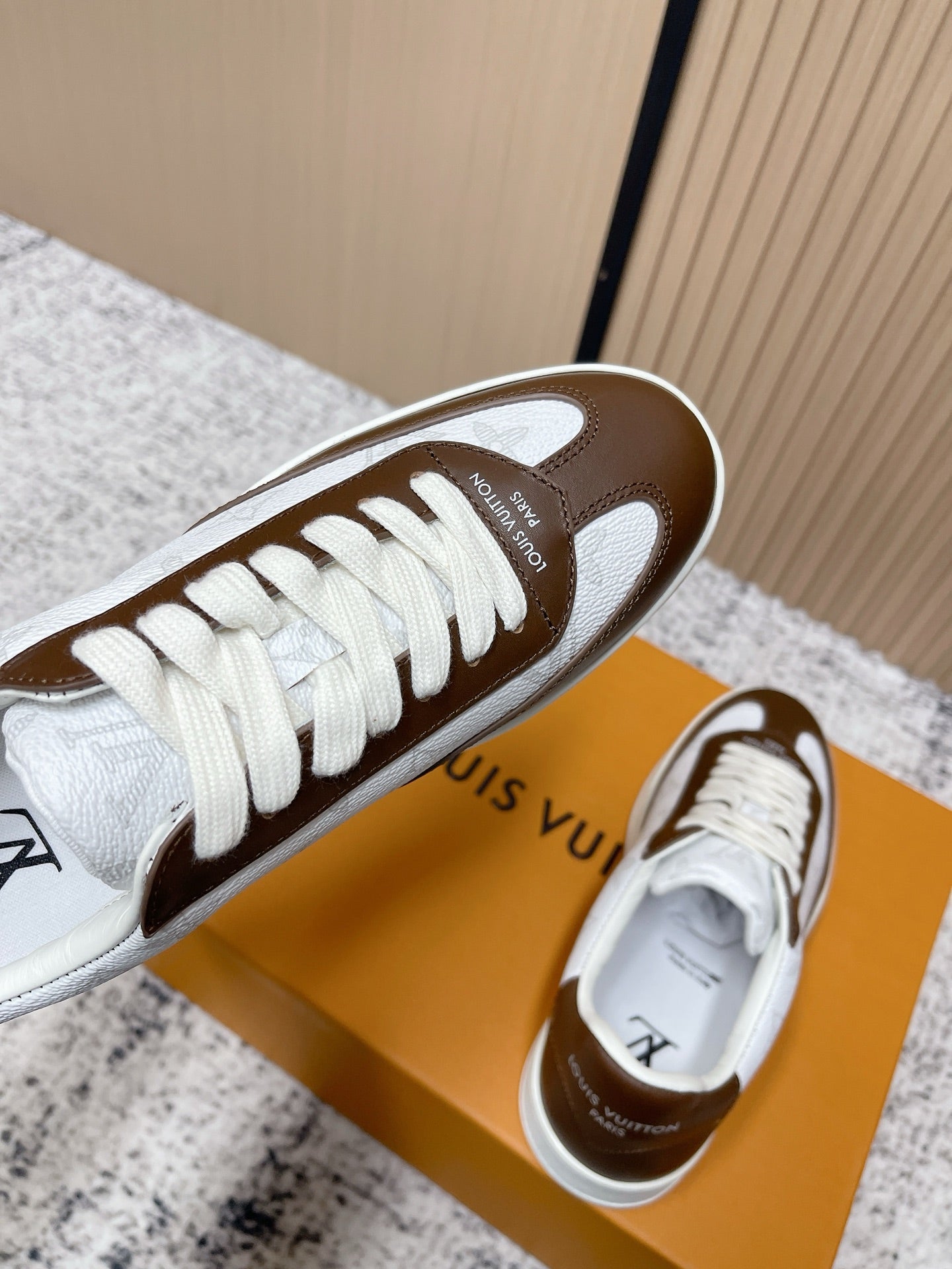 Brown-and-white low-top sneakers with lace-up front and LV sidewall logo