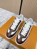 Brown-and-white low-top sneakers with white laces and side logo detail
