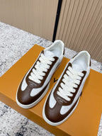 Brown-and-white low-top sneakers with white laces and side logo detail