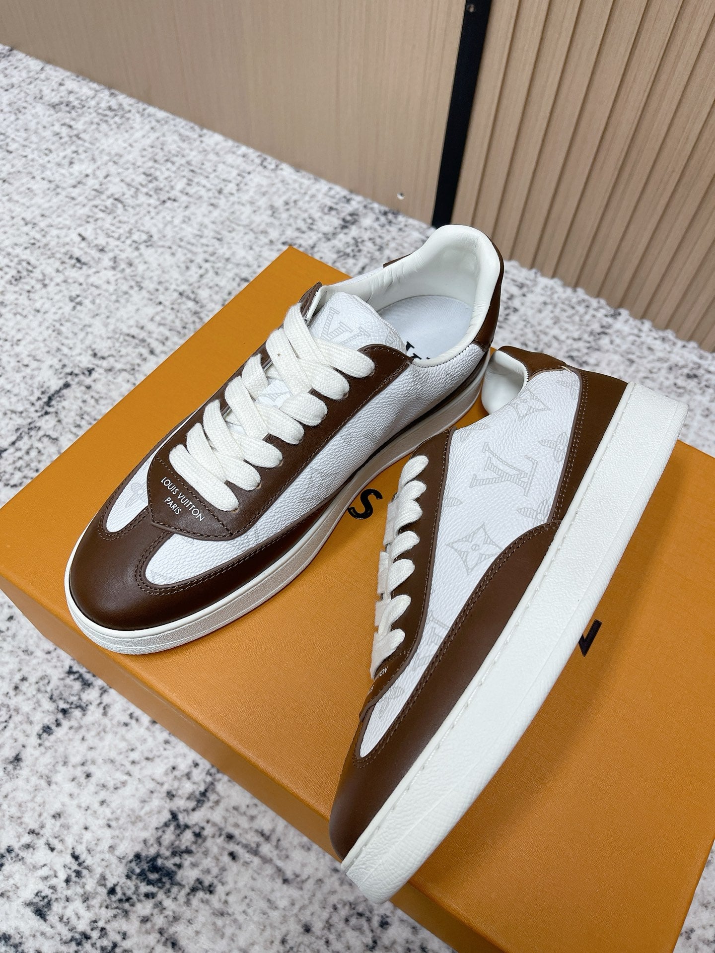 Brown-and-white low-top sneakers pair with white laces and chunky white midsole