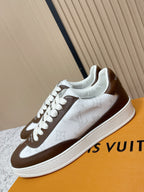 Brown-and-white leather low-top sneakers with white laces and side stripe logo