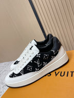 Louis Vuitton unisex sneakers, close side view with black monogram print and white laces