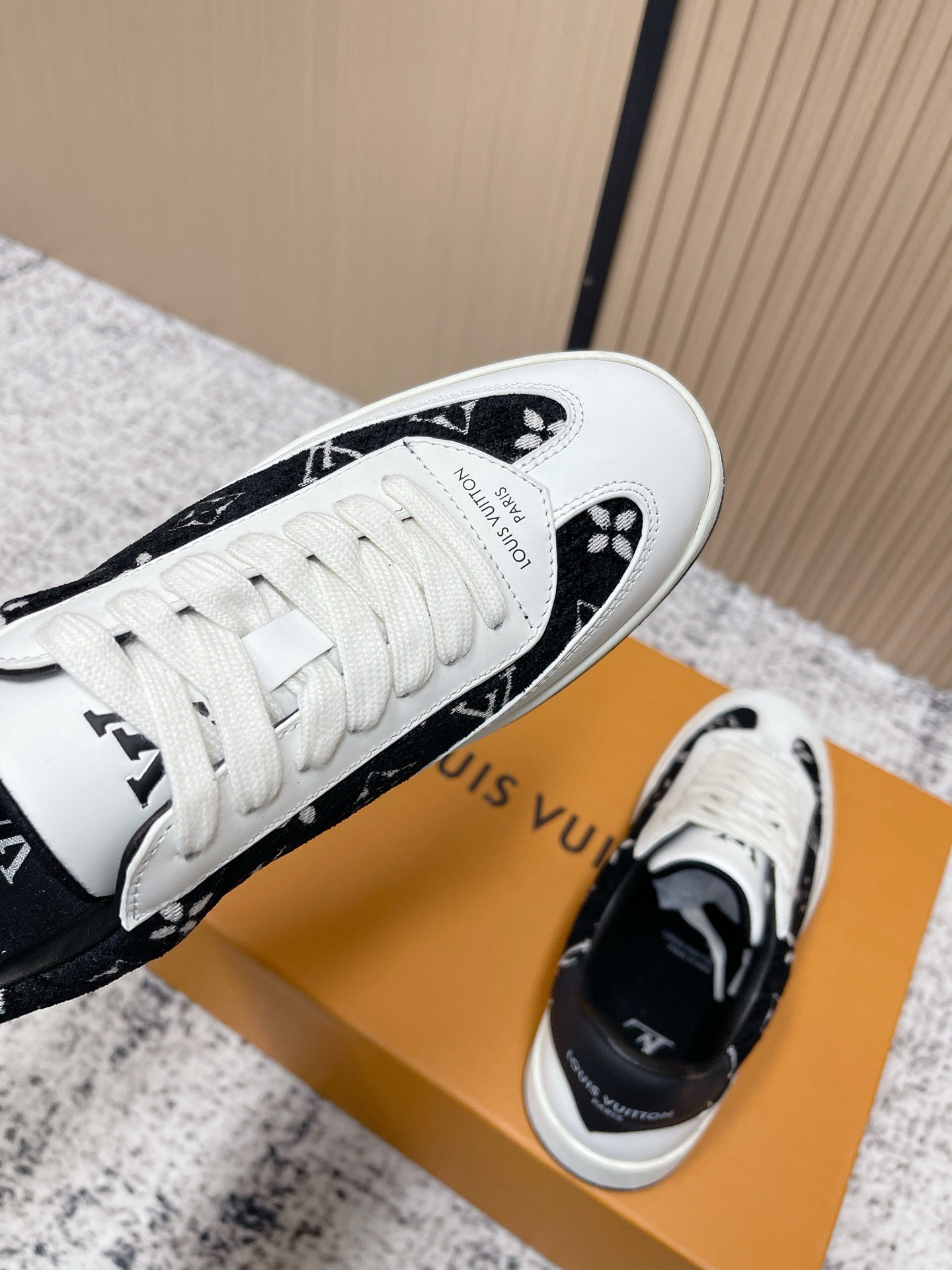 Louis Vuitton unisex sneakers, toe and lace view with black monogram trim