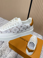 Louis Vuitton unisex sneakers, side view in white with monogram stripe and gold heel lining