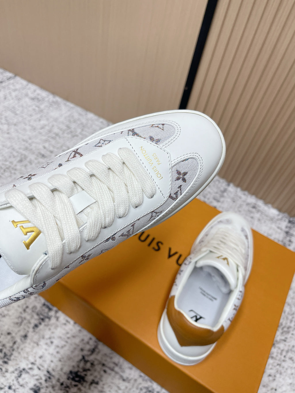 Louis Vuitton unisex sneakers, white toe and side profile with monogram print and gold accents