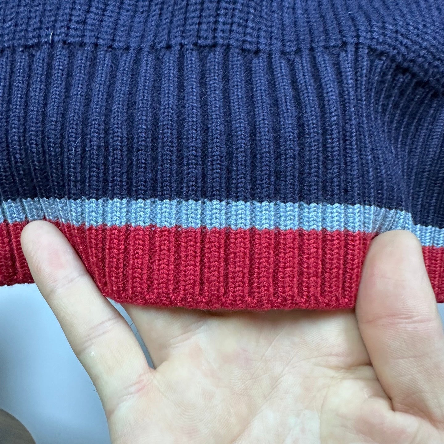Dark blue knit collar with red, gray, and white striped band