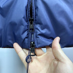 Dark blue Moncler jacket zipper with black pull tab and cord puller