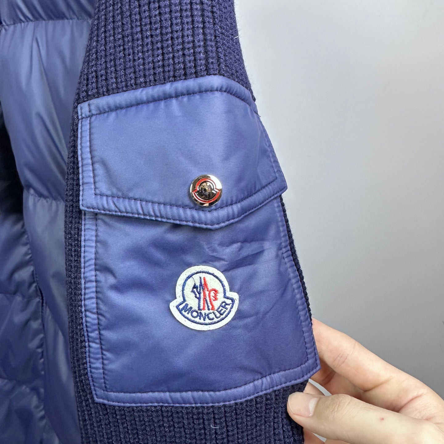Dark blue Moncler padded jacket with chest pocket and circular logo patch