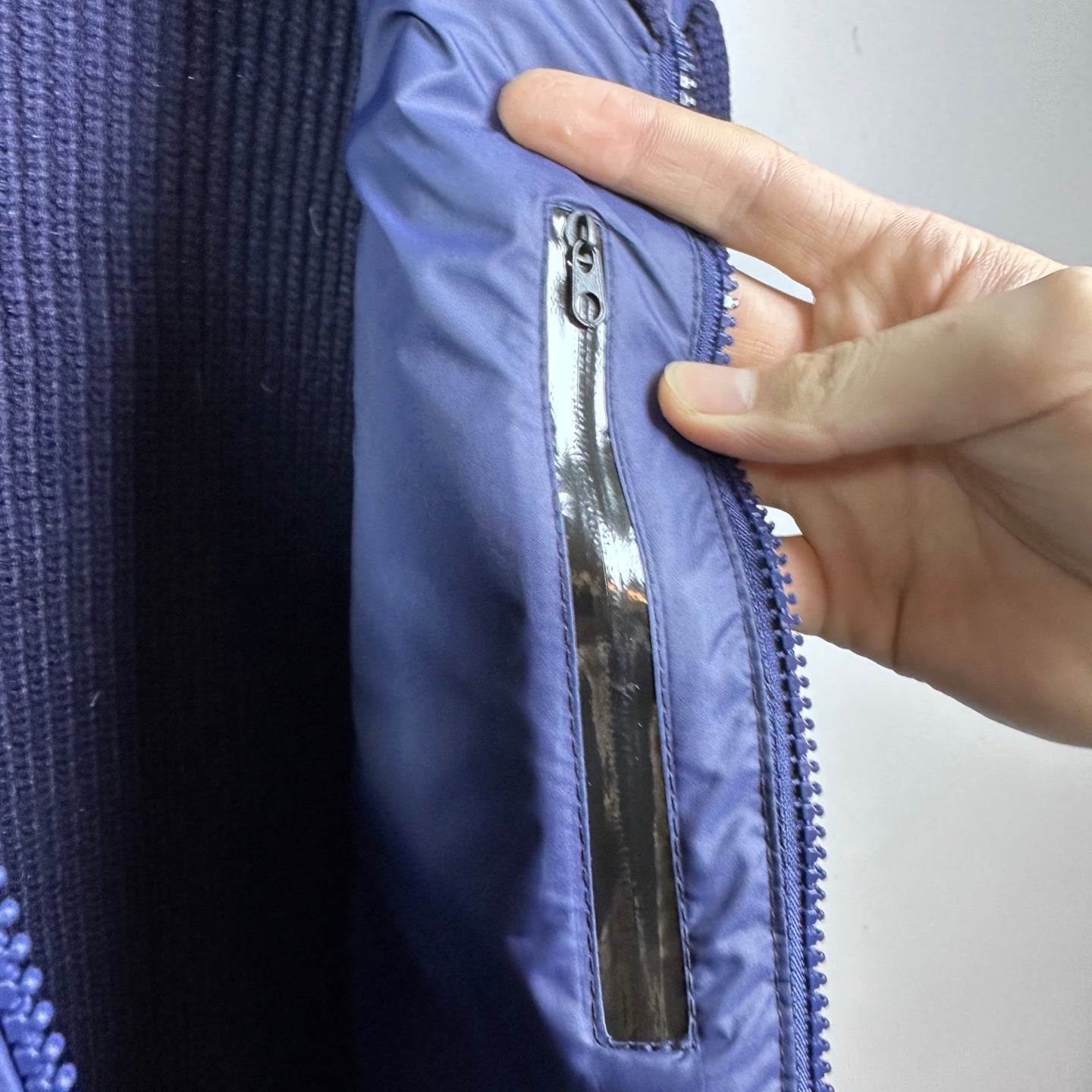 Dark blue Moncler jacket zip placket with metal puller detail