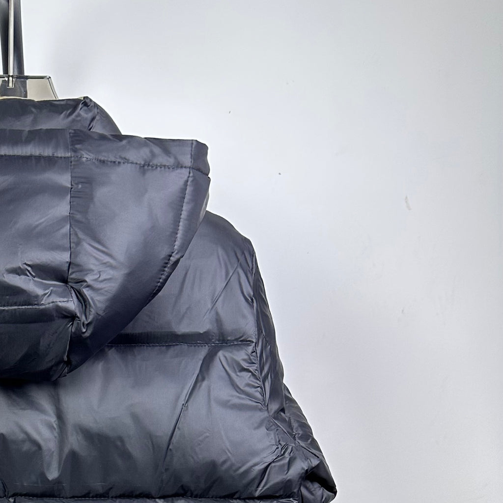 Long Moncler puffer jacket back with dark navy quilted hood and padded shoulders