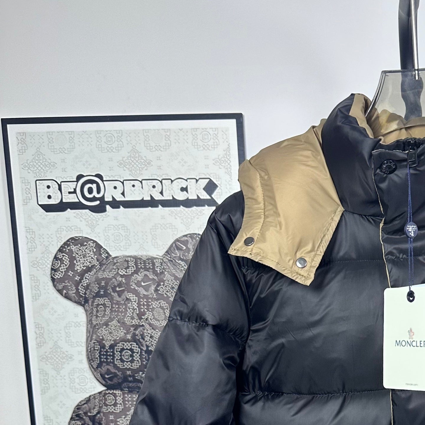 Long Moncler puffer jacket with beige hood panel and dark navy front