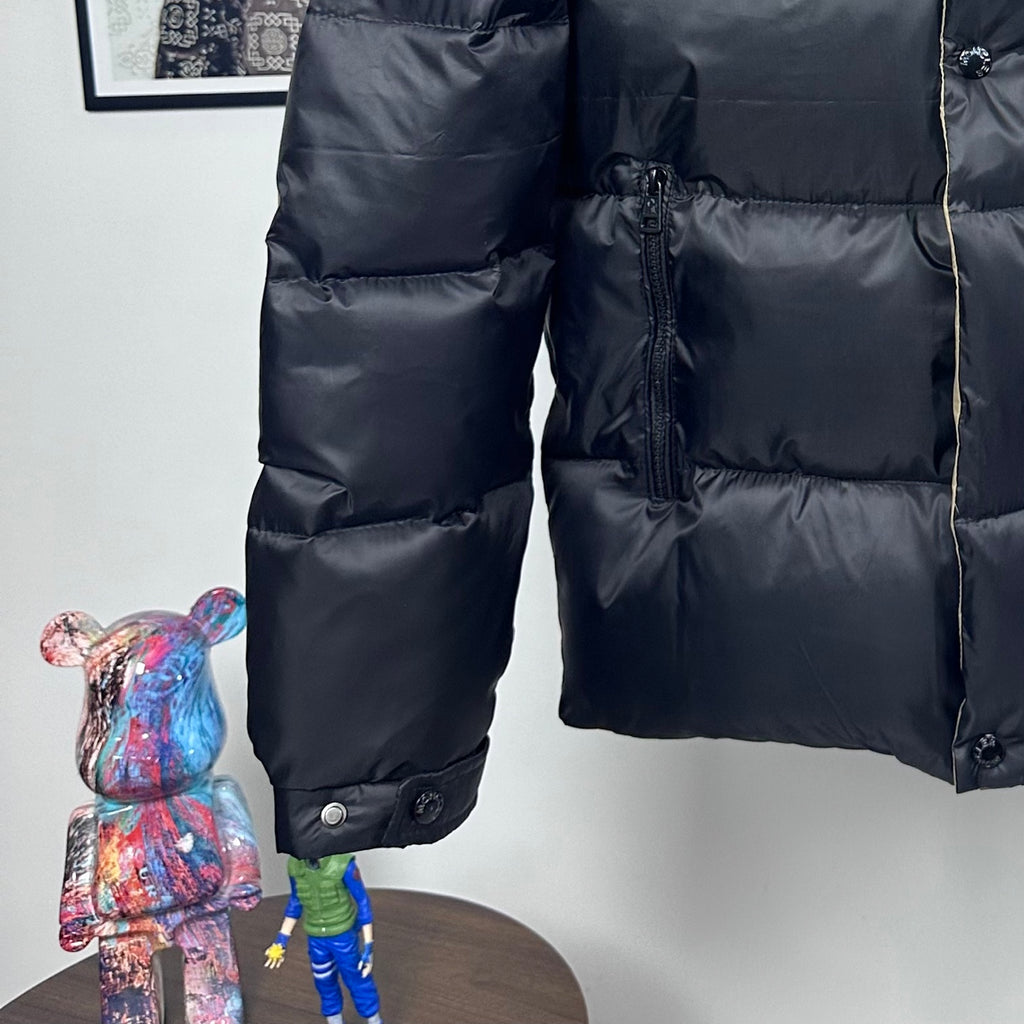 Long Moncler puffer jacket with dark navy quilted body and front zip