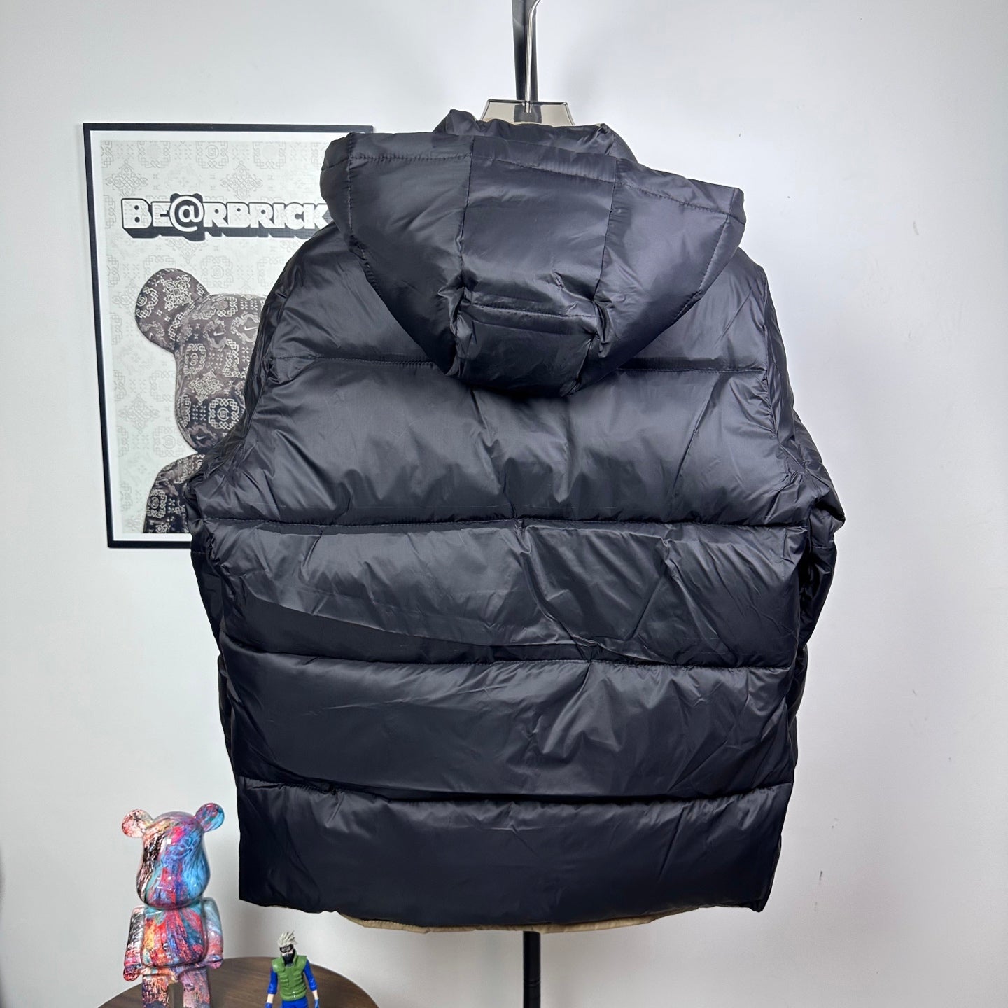Long Moncler puffer jacket with dark navy hood and layered quilted padding