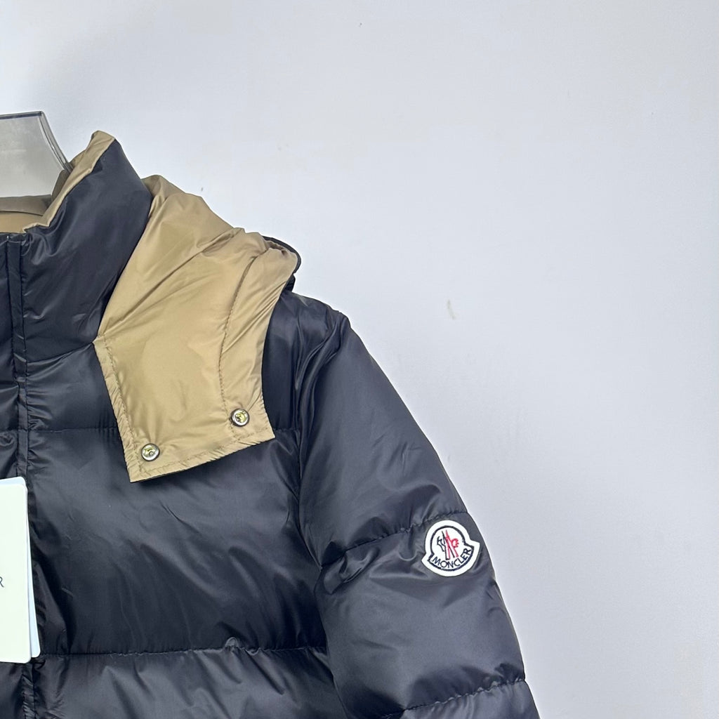 Long Moncler puffer jacket with beige hood yoke and dark navy sleeve logo patch
