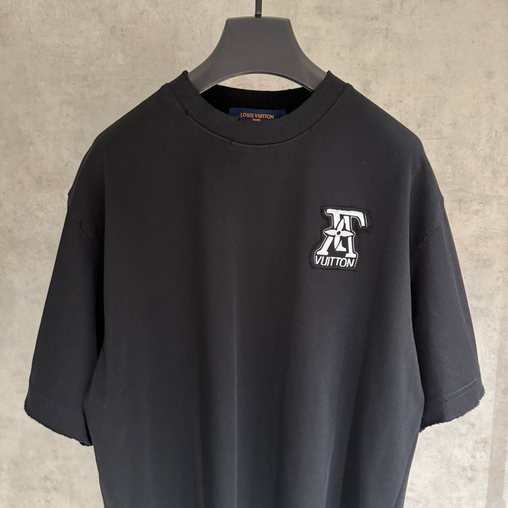 Black short-sleeve T-shirt with Louis Vuitton logo patch on chest