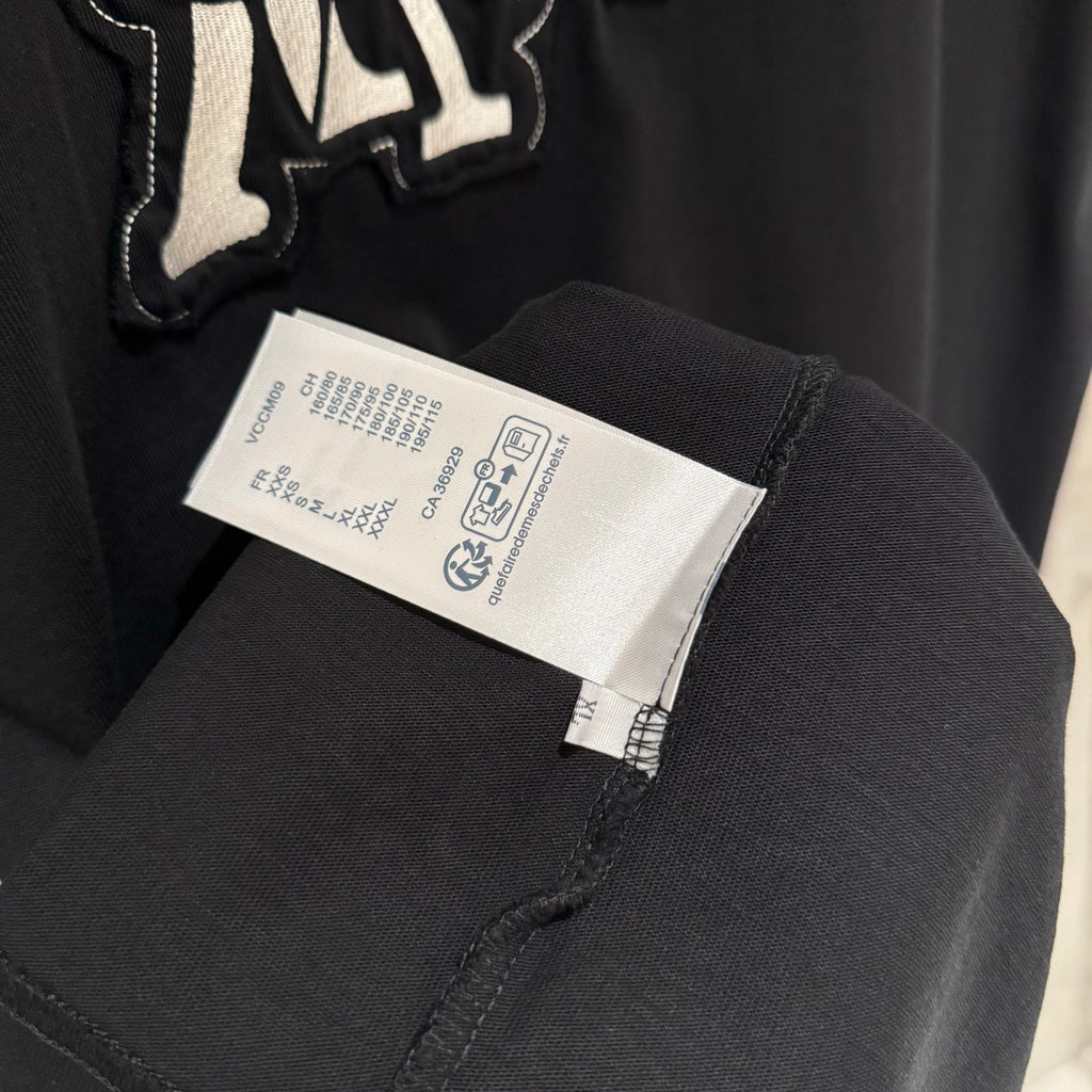 Black T-shirt with inner size and care label near side seam