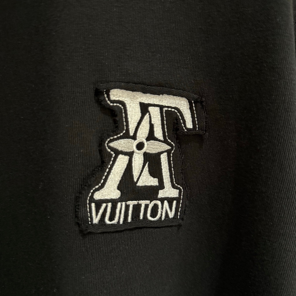 Black T-shirt with embroidered Louis Vuitton logo patch on chest