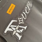 Louis Vuitton T-shirt front graphic with LV-style emblem, yellow care label
