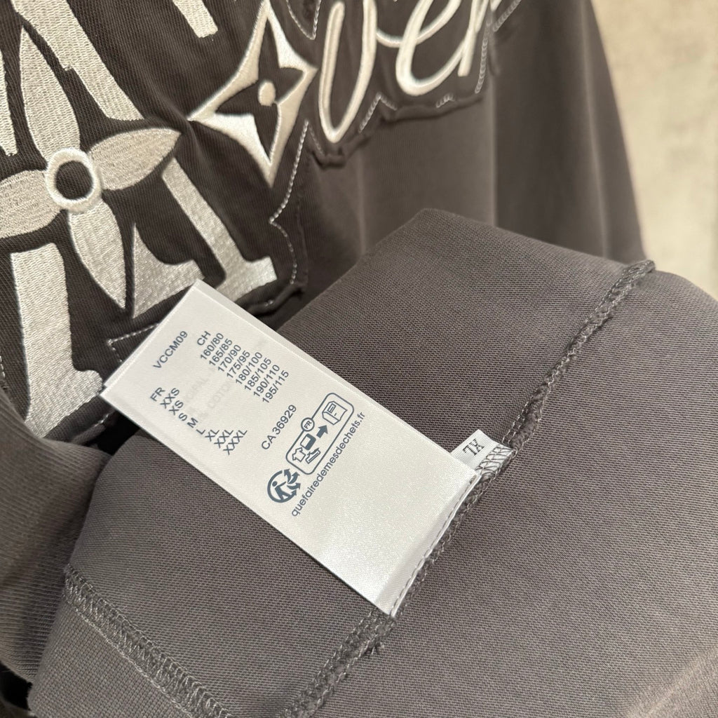 Louis Vuitton T-shirt inner care label on dark gray fabric near neckline