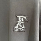 Louis Vuitton logo patch on dark gray T-shirt, embroidered emblem at chest