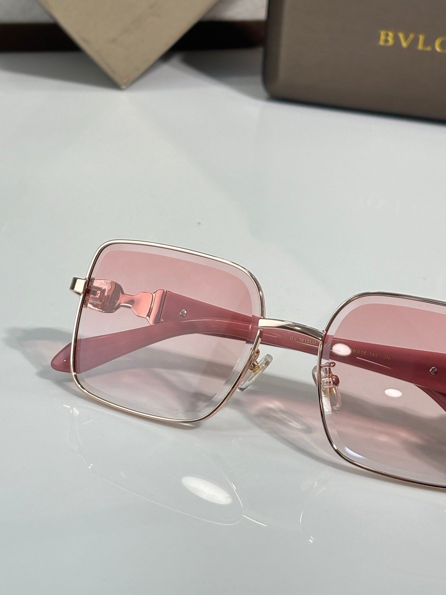Bvlgari glasses with pink frame and rose-tinted rectangular lenses