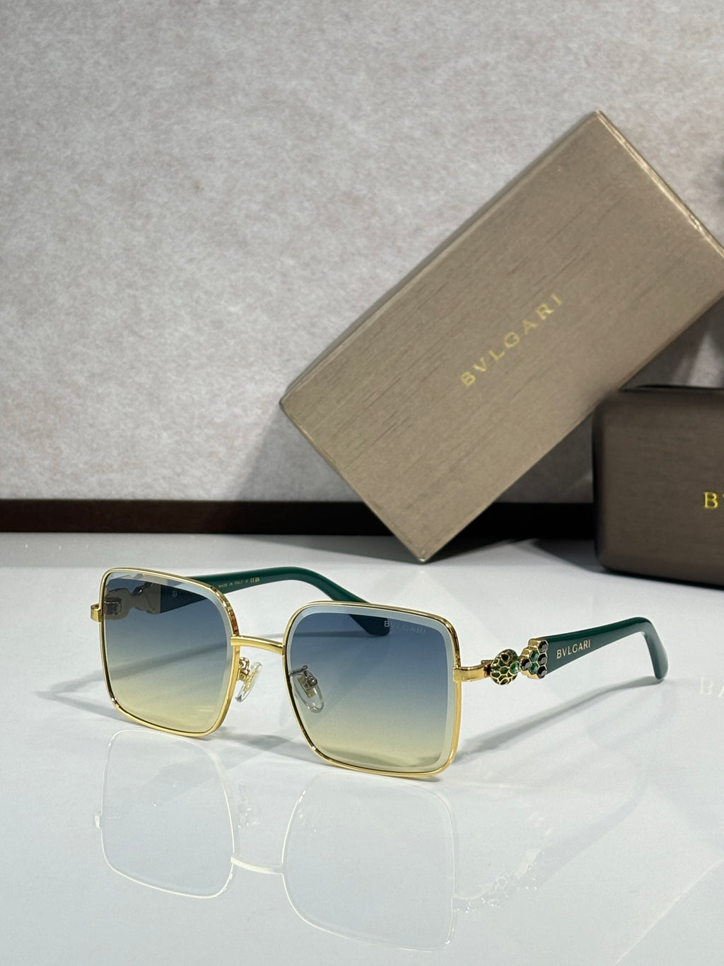 Bvlgari glasses with green-accent frame and light yellow-tinted lenses