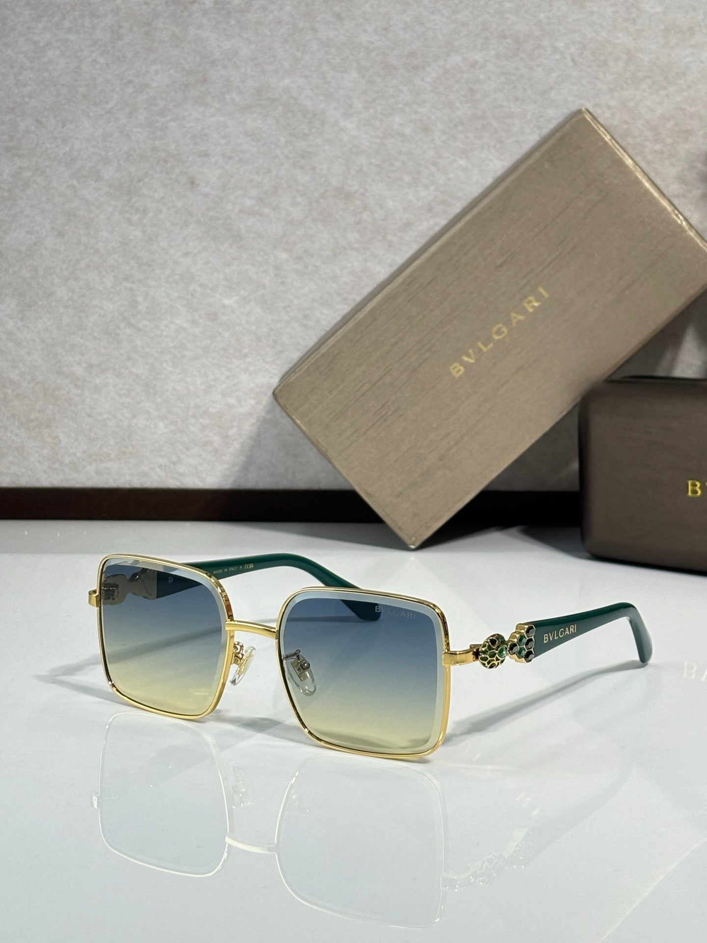 Bvlgari glasses with green-accent frame and light yellow-tinted lenses