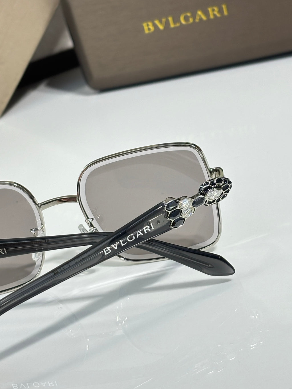 Bvlgari glasses with silver frame and dark temple detail, clear lenses