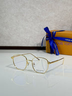 Round sunglasses with gold frames and clear lenses