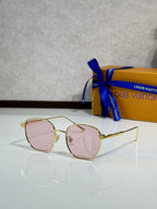 Round sunglasses with gold frames and pink-tinted lenses