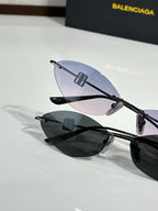 Balenciaga sunglasses with dark lenses and black-tone metal frame.