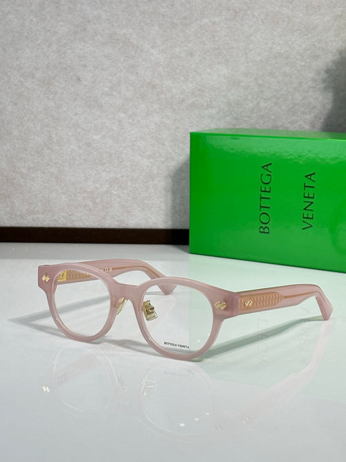 Bottega Veneta eyeglasses with pink frame and gold textured temples