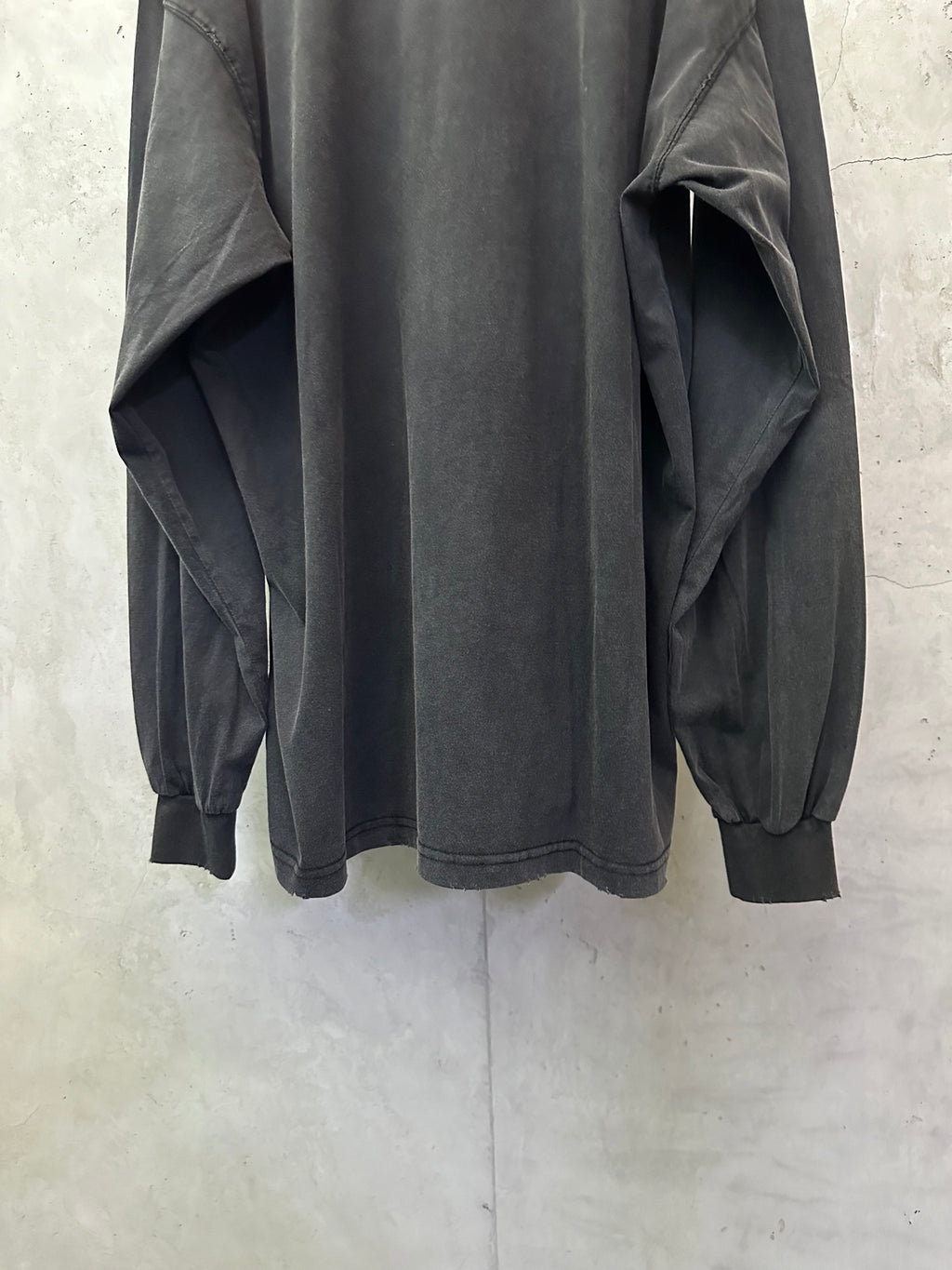 Balenciaga long-sleeve top, dark gray, back view with gathered cuffs