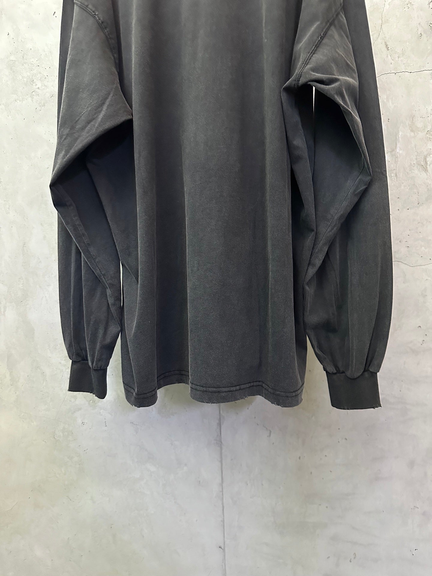 Balenciaga long-sleeve top, dark gray, back view with gathered cuffs