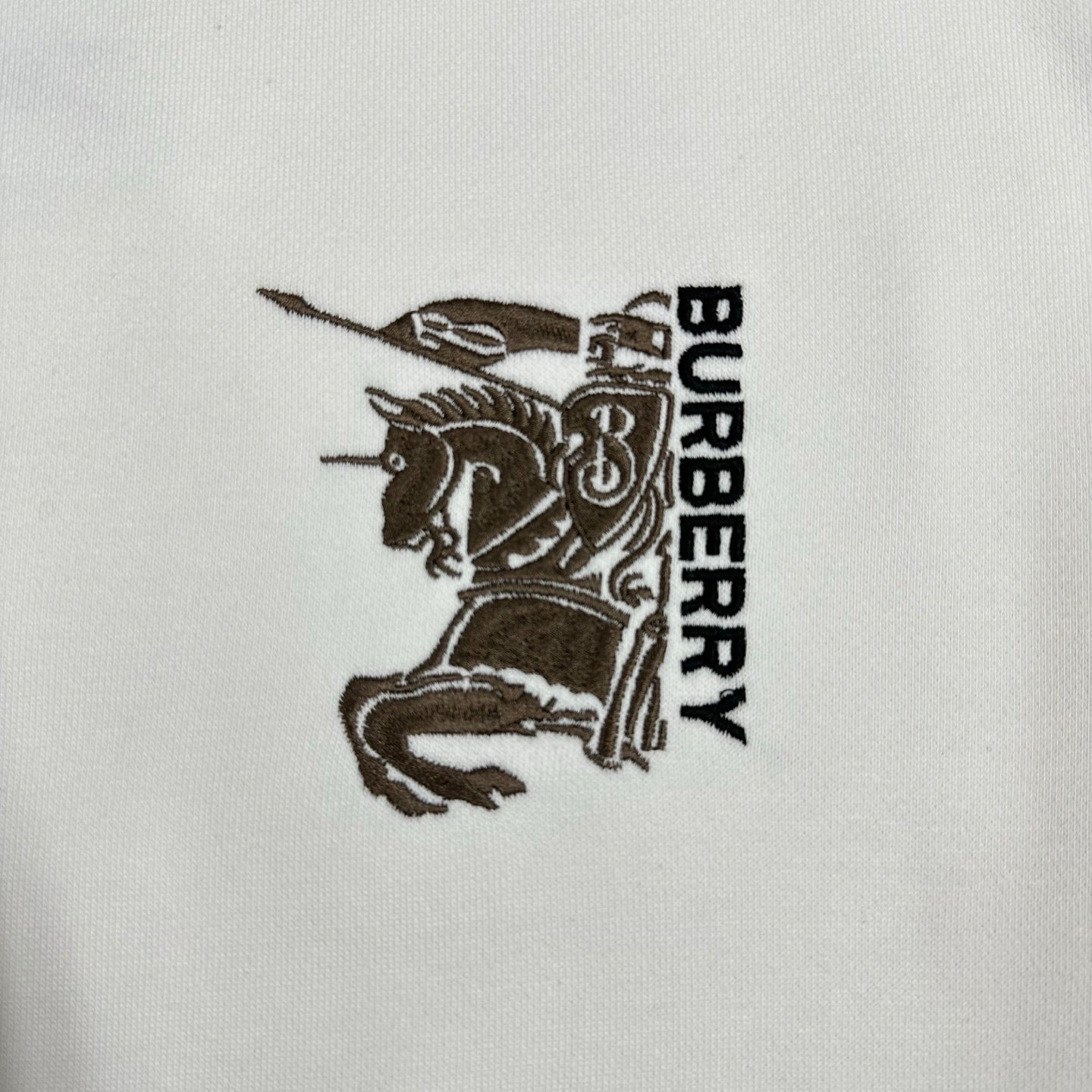Men's Burberry white sweatshirt logo embroidery close-up with "BURBERRY" text