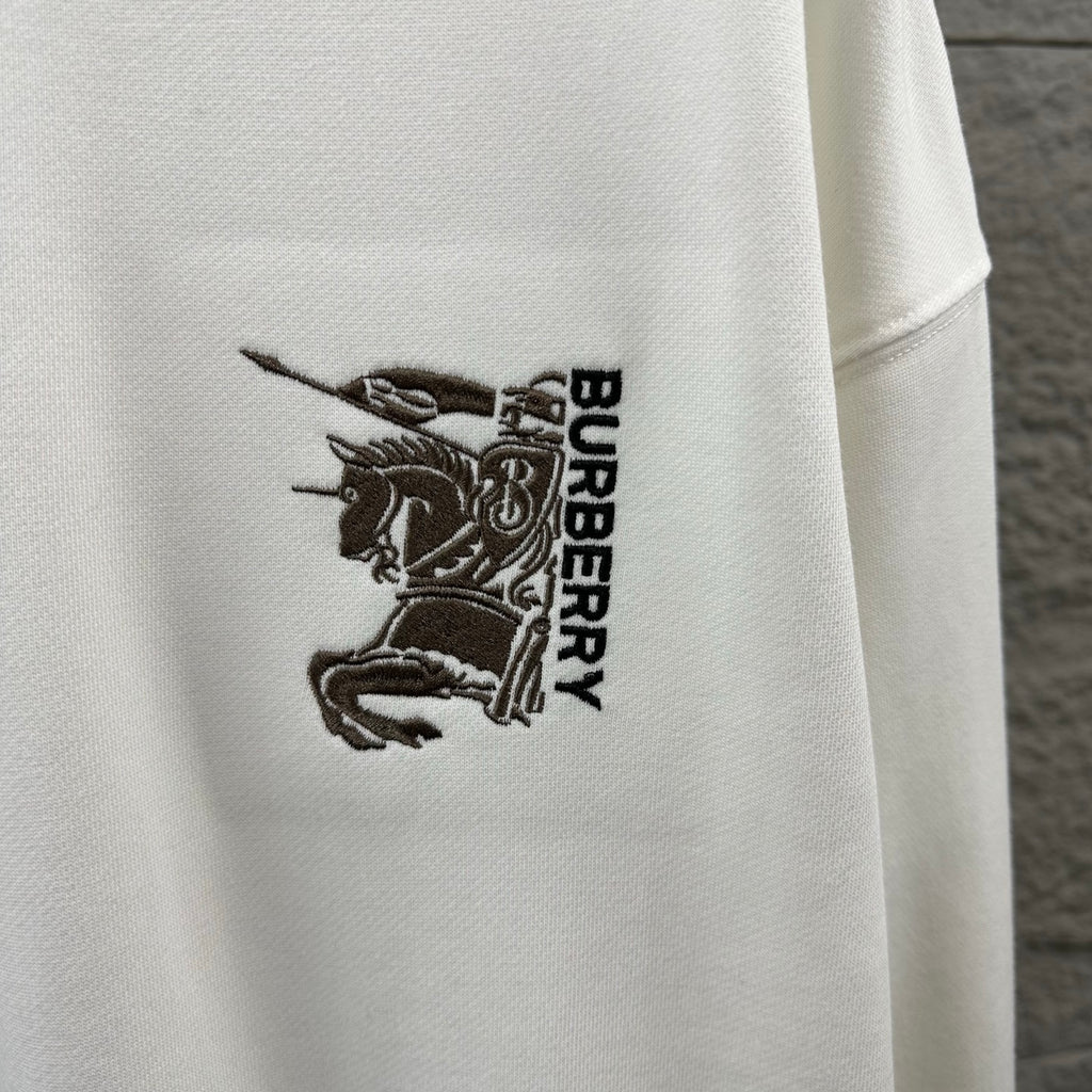 Men's Burberry white sweatshirt logo embroidery close-up, "BURBERRY" vertical text