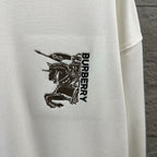 Men's Burberry white sweatshirt logo embroidery close-up, "BURBERRY" vertical text