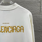 White sweatshirt back with gold Balenciaga text graphic